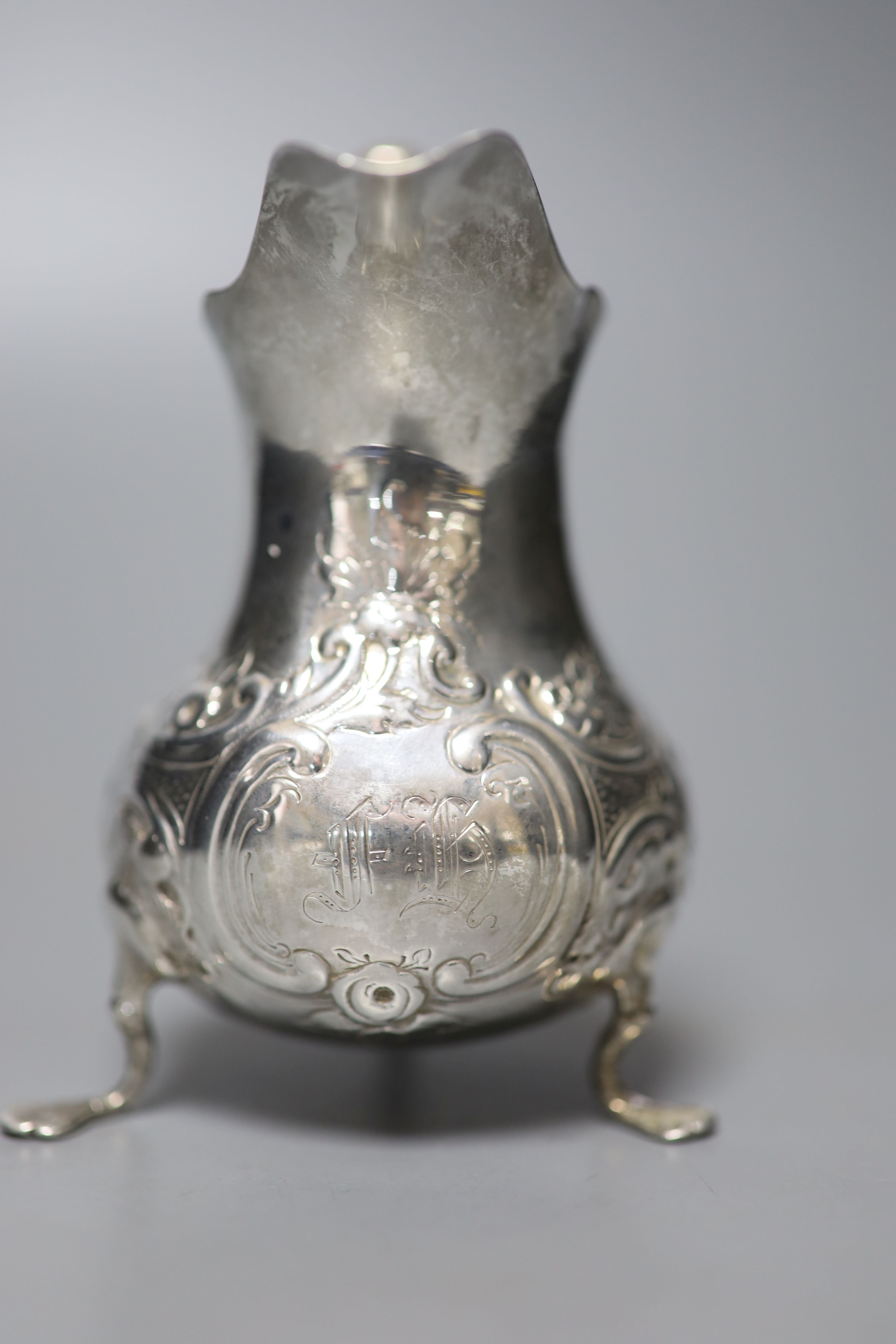 A George III silver cream jug, with later embossed decoration, London, 1767, 10cm, 61 grams.